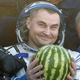Russian cosmonaut Alexey Ovchinin holds a watermelon